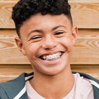 ortho-metal-braces young smiling boy wearing braces